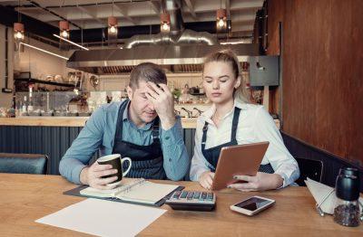 Nervous manager checking restaurant finances