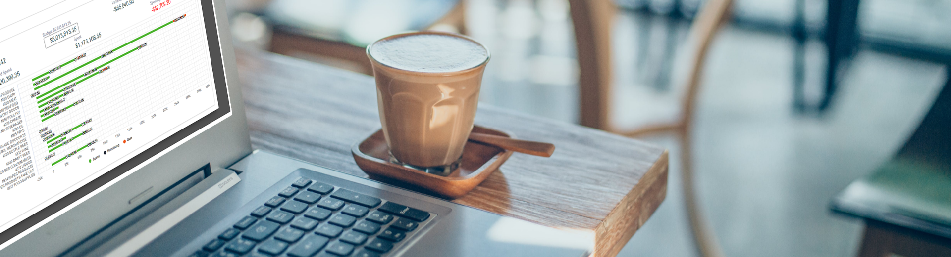 Coffee next to laptop with data