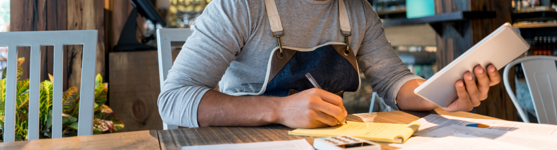 Restaurant manager reviewing tablet at table