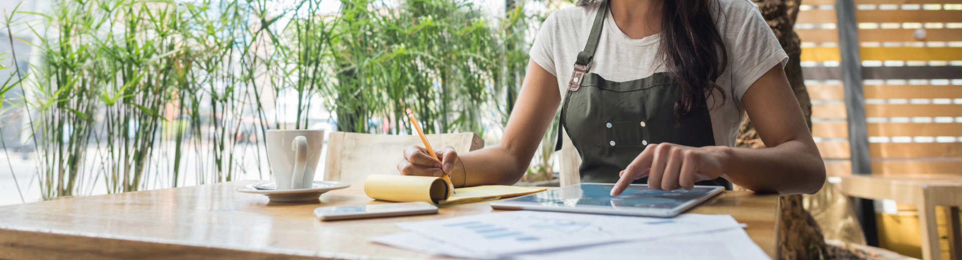 Restaurant staff member reviewing reports at table