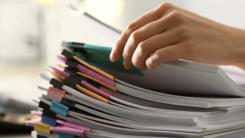 Stack of files with hand