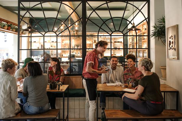 Restaurant server taking food order in dining room