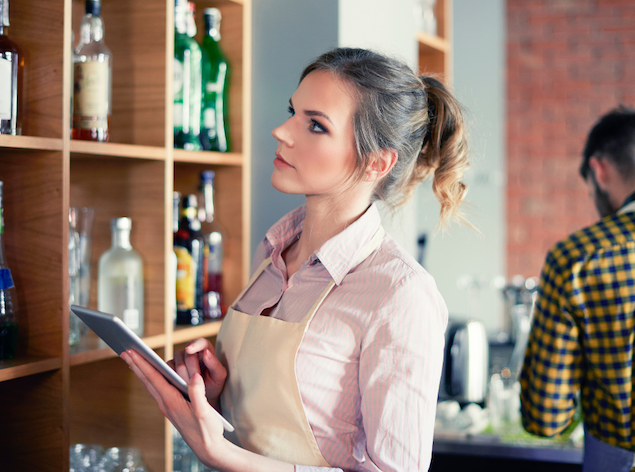 Woman taking restaurant inventory