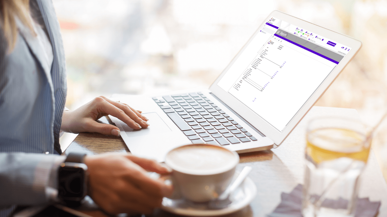 RASI Restaurant Accounting Software on laptop with coffee