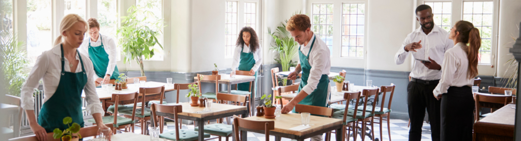 Restaurant staff preparing tables for service