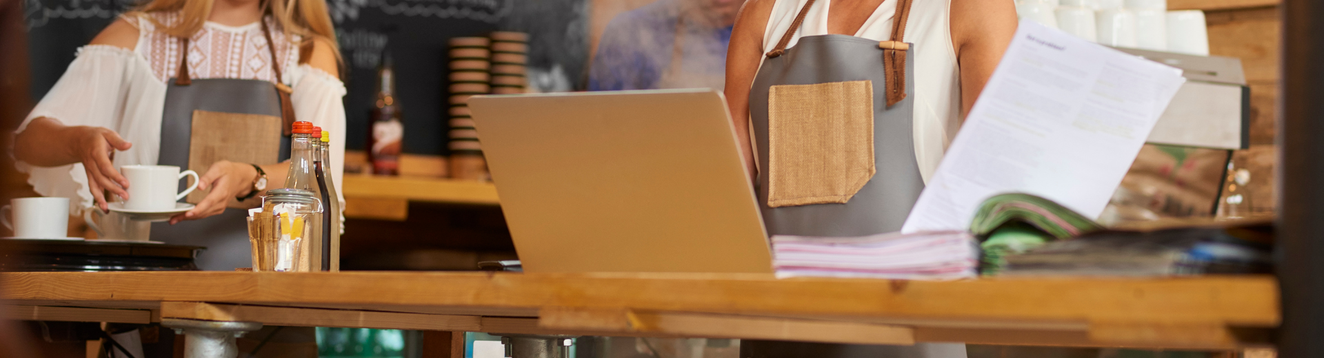 Restaurant operators inputting data into laptop