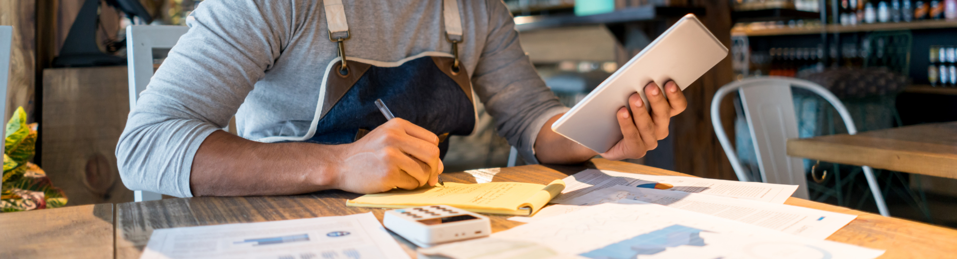 Restaurant operator writing on notepad