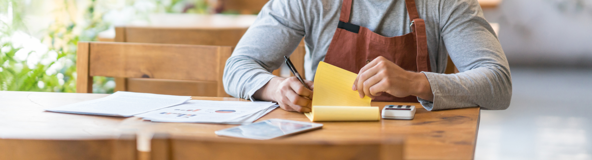 Restaurant operator writing notes on notepad
